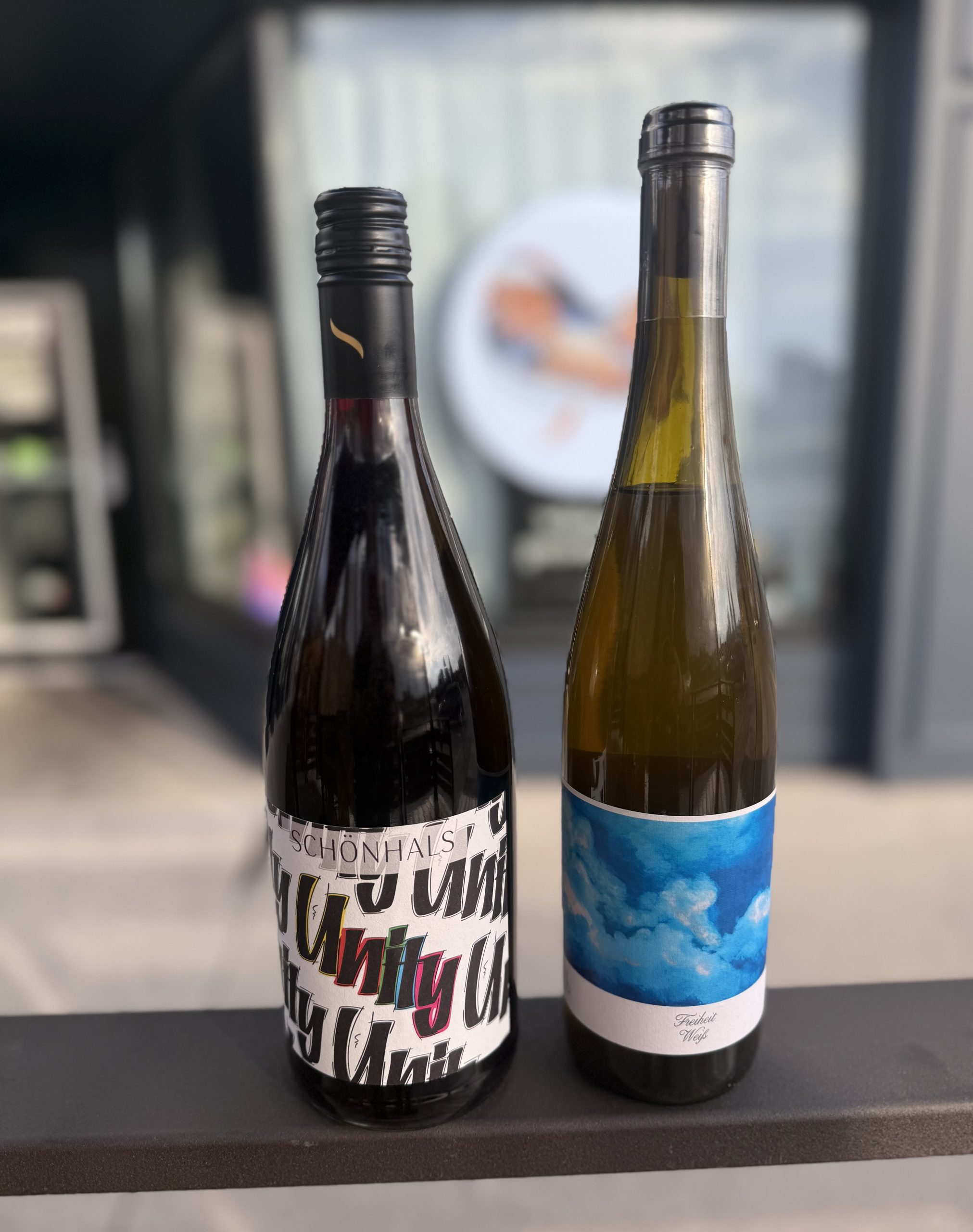 Two bottles of German wine sitting on a table at odd duck wine and provisions in Kitchener.