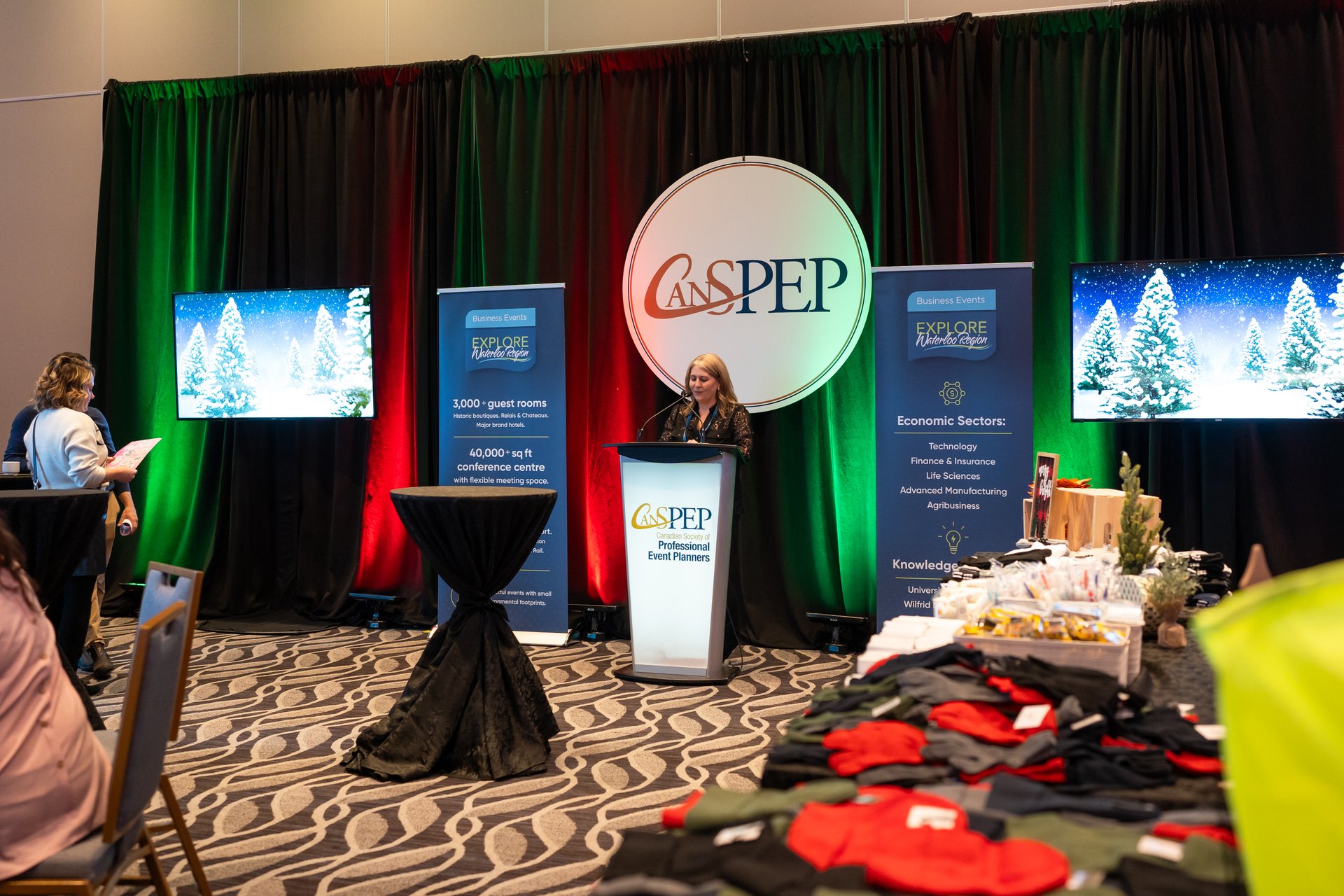 Director of Business Development at Explore Waterloo Region, Jennifer Eddigns, addresses the attendees prior to the social impact event at the CanSPEP and MPI Holiday Event.