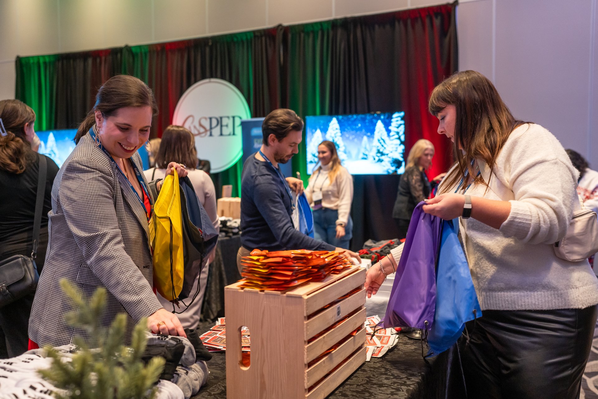 Attendees choose items arranged on tables to add to their donation bags at the CanSPEPGives Back event in Toronto.