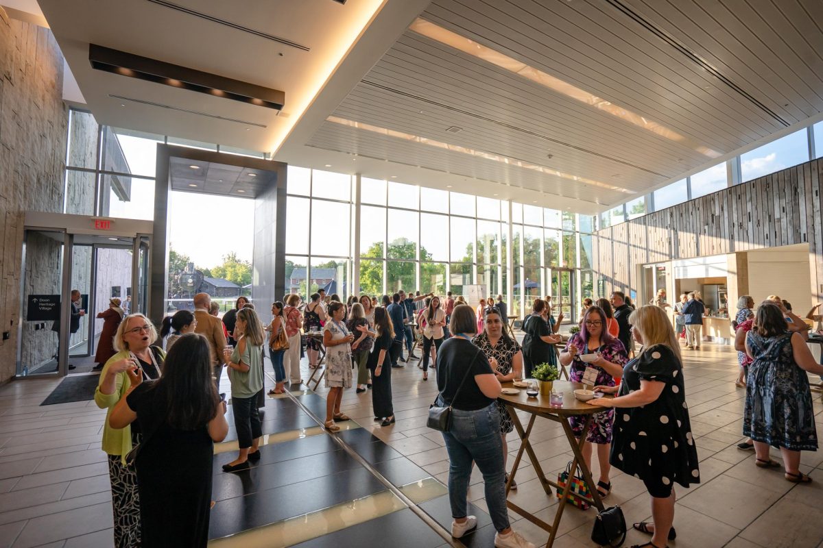 The glassed-in atrium at the Waterloo Regional Museum. It is filled with attendees attending the CSAE Summer Summit.