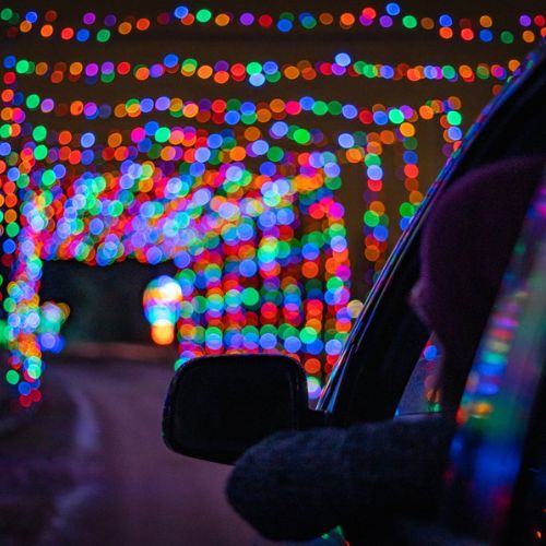 A car driving through the large light tunnel that is part of Gift of Ligths at Bingemans