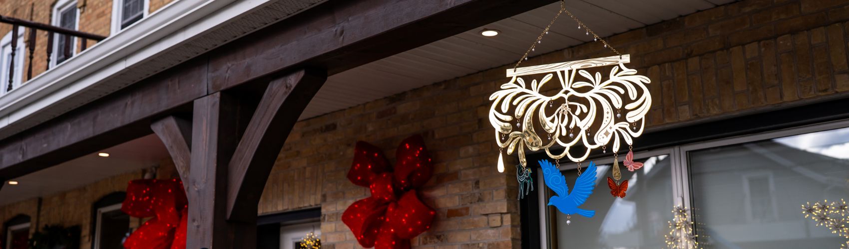 Laser cut gold metallic mistletoe base with woodland creatures and berries hanging from it, created byartist Brianne Burnell. Part of the 2025 Mistletoe Trail 