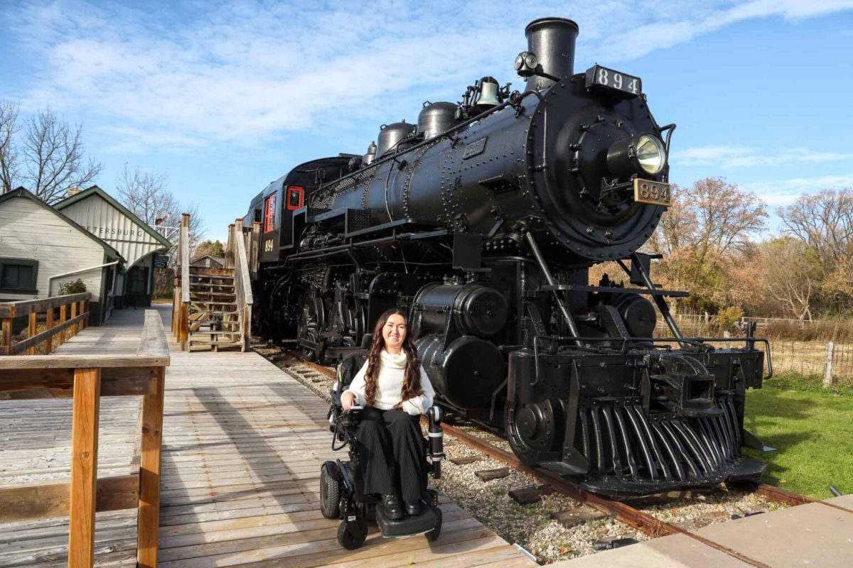 Disability advocate Tori Hunter is in her wheelchair in front of the steam locomotive at the Ken Seiling Waterloo Region Museum in Kitchener