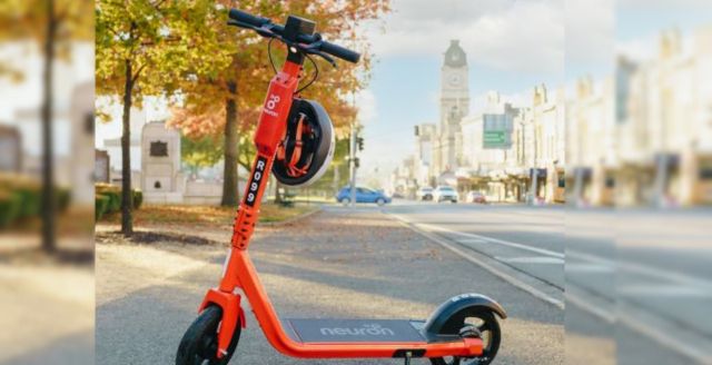 An orange Neuron mobility e-scooter on a bike path in waterloo Region.