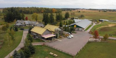 A drone shot of the farm and event spaces at Willibald Farm Distillery, Brewery & Restaurant in the countryside in Ayr, Ontario. 