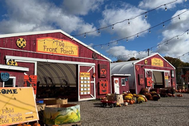 Two large outdoor sheds at Benjamin Tree Farm. OUtside it is decked out with fall decor for sale.