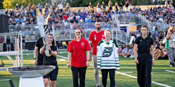 The end of the torch run with the cauldron being lit during the Opening Ceremonies of the Waterloo Region 2026 Ontario Summer Games.