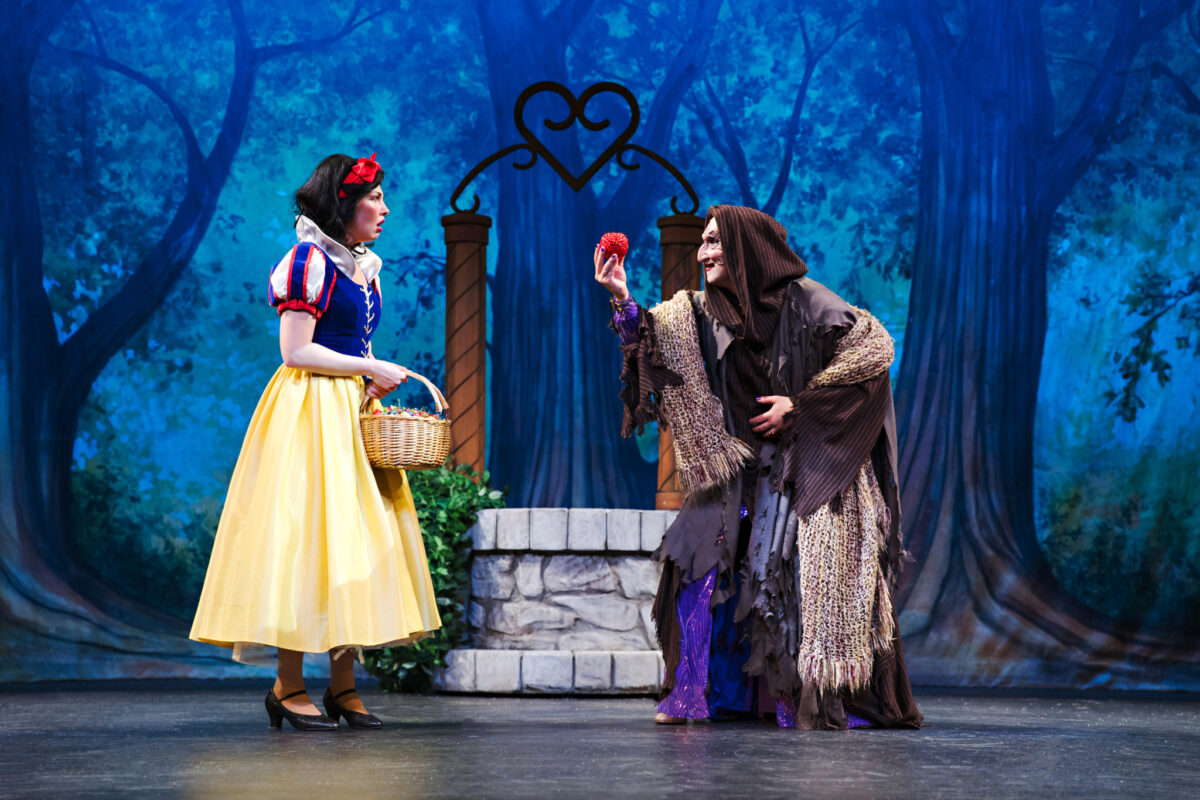Two actors in the costumes of Snow White and the Wicked Witch on stage at Drayton Entertainment's St. Jacobs Country Playhouse for the production of Snow White and the 7 Tenors: A Panto.