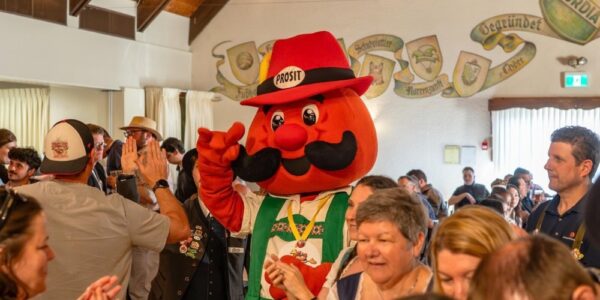 Kitchener-Waterloo Okotberfest mascot, Onkel Hans, is greeted by a crowd of people celebrating Oktoberfest at Concordia Club.