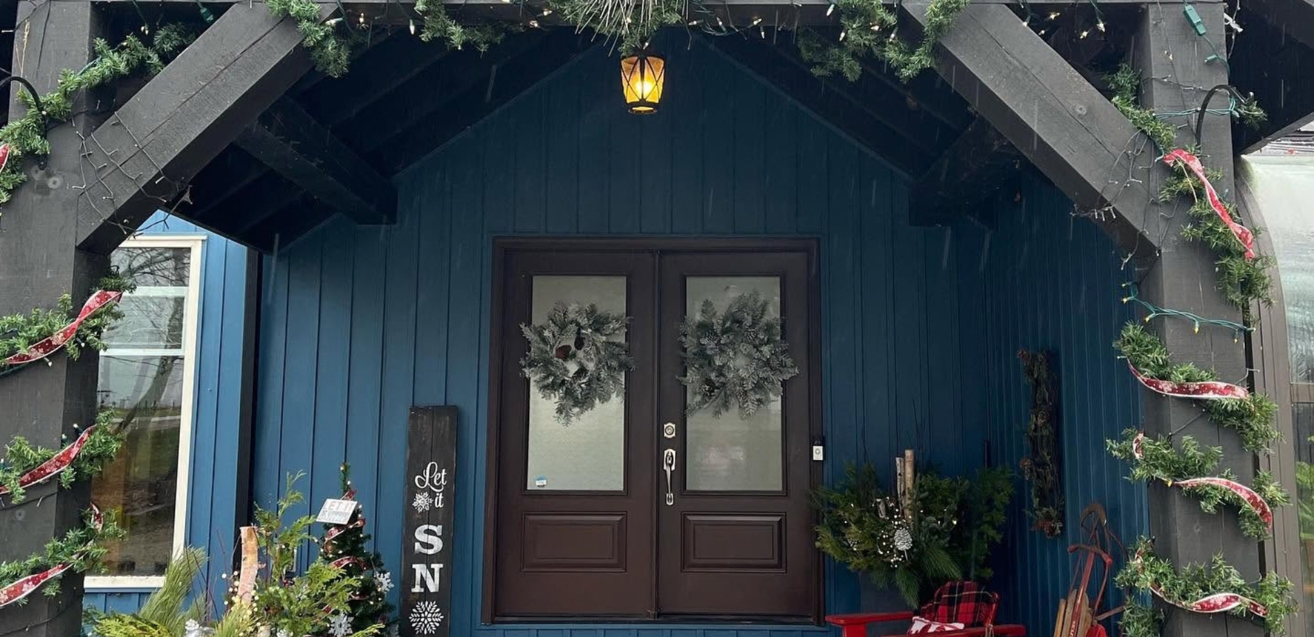 The front brown door and blue siding of The Blue Bruce Bed and Breakfast in St. Jacobs